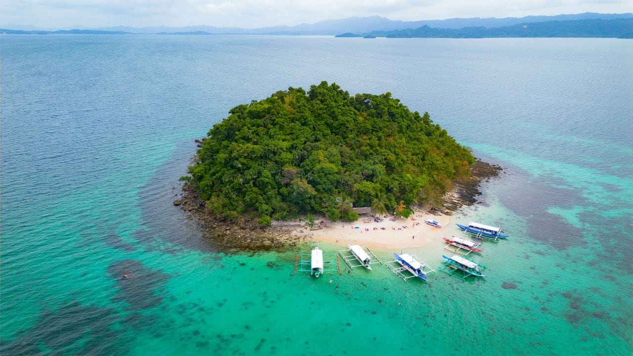 Boat island-hopping between sandbars near Siargao